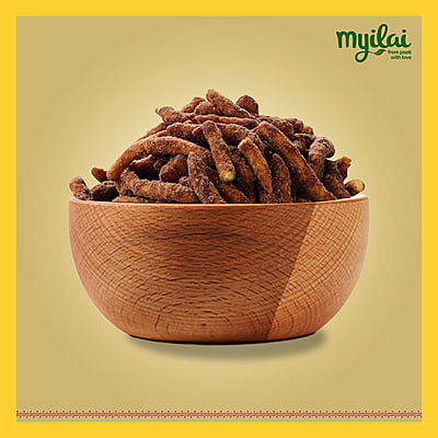 A bowl of Karupatti Sev is placed in the centre with myilai logo A bowl of Karupatti Sev is placed in the centre with myilai logo