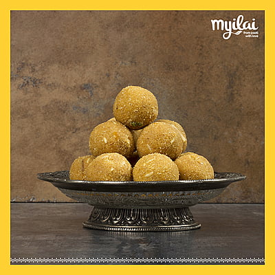 Plater of Navadhanya Laddu is placed in centre with Myilai Logo.