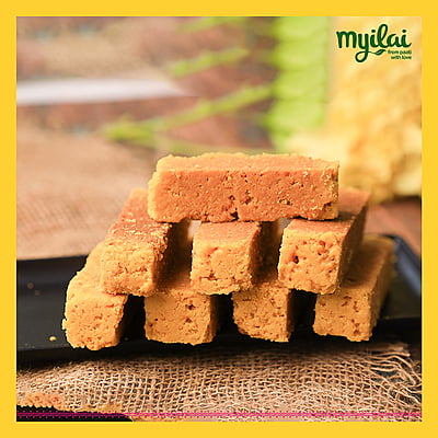 Blocks of Traditional Mysore Pak on a plate with Myilai logo