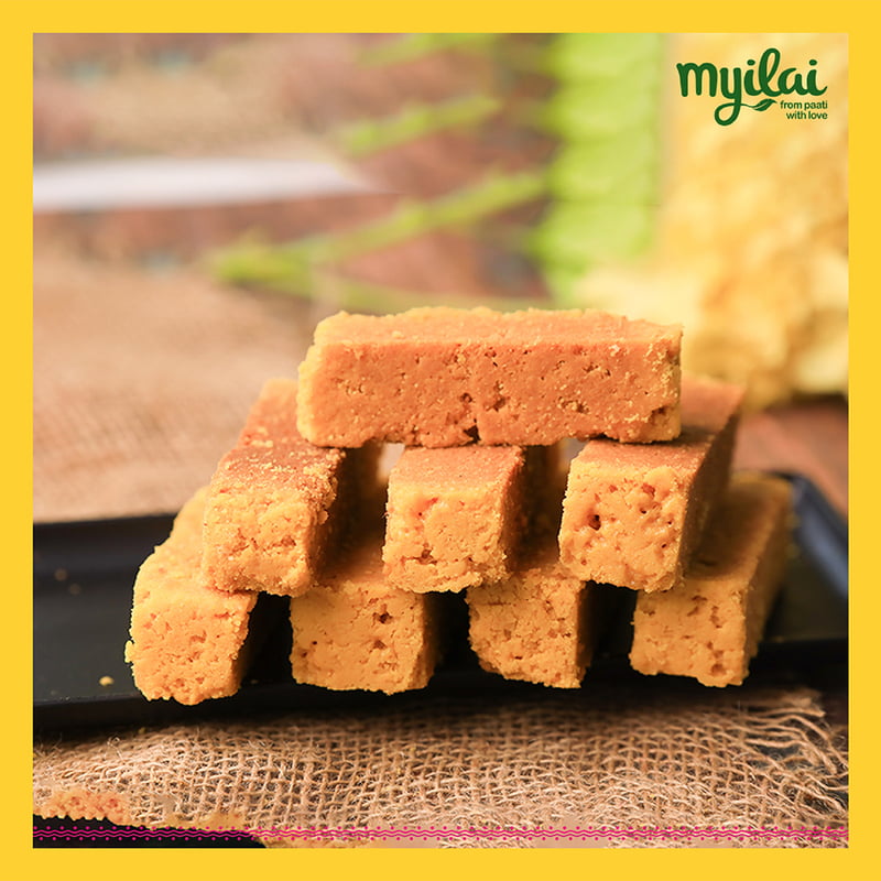 Blocks of Traditional Mysore Pak on a plate with Myilai logo